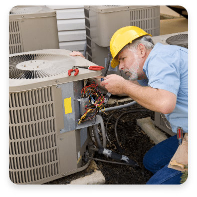 HVAC technician repairing air conditioning unit, demonstrating maintenance and service expertise for home comfort.