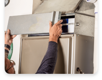 Technician performing HVAC maintenance by adjusting a heating unit, highlighting the importance of regular service for energy efficiency and comfort.