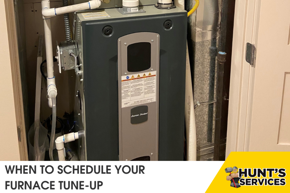 Furnace in a residential setting with visible pipes and safety labels, highlighting the importance of scheduling furnace tune-ups for efficient home heating in Tacoma, WA.