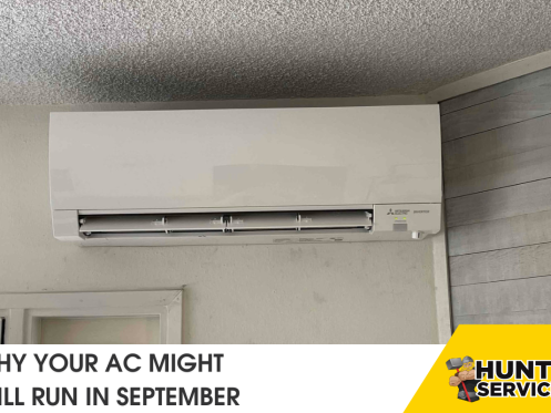 Air conditioning unit mounted on a wall, highlighting reasons why your AC might still run in September, with Hunt's Services branding.